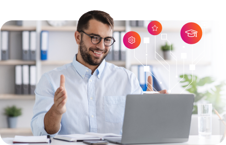 A man sitting in front of a laptop with icons on it.