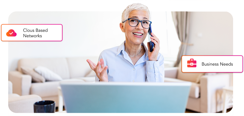 A woman is talking on the phone while sitting in front of a laptop, utilizing Conversational AI for automated communication.