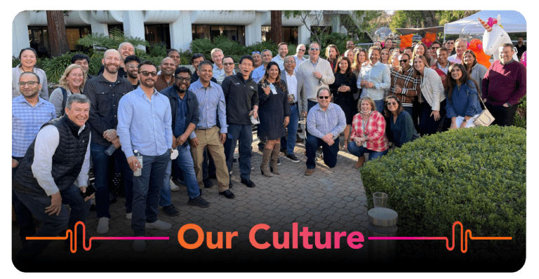 A group of people standing in front of a building showcasing our culture.