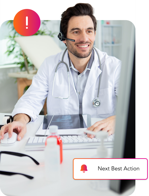 A doctor at his computer, utilizing Conversational AI for Revenue Cycle Management.