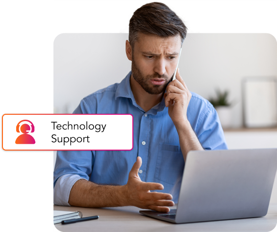 A man sitting at a desk with a laptop and a technology support button for B2B technology support.