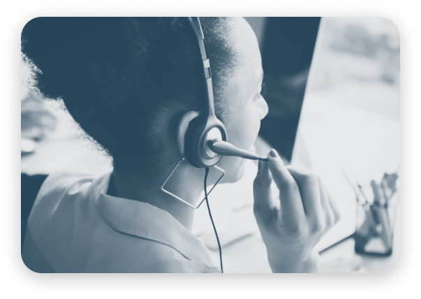 A woman wearing a headset at a computer, with voice capture overlay enabled.