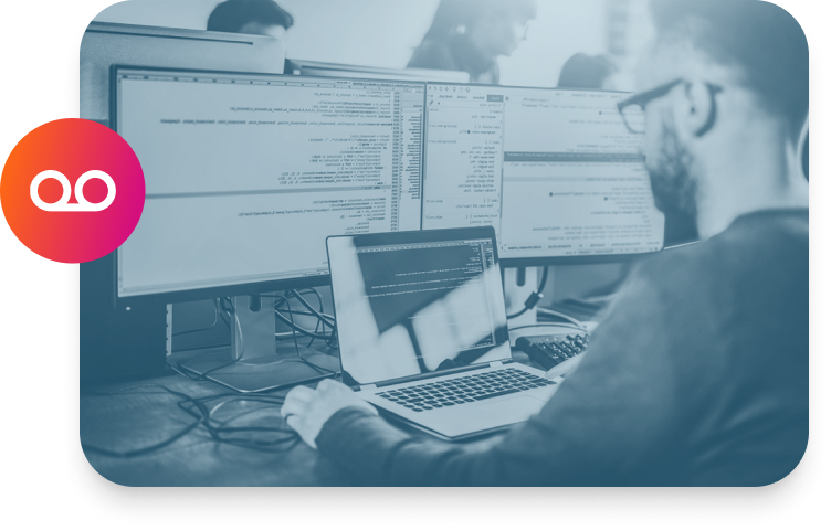 A man is working on a computer with two monitors for Compliance Recording.